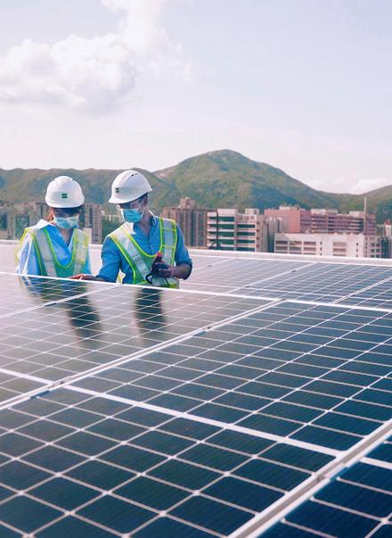 Workers on the roof inspecting the Solar Panels at Goodman Western Plaza in Hong Kong